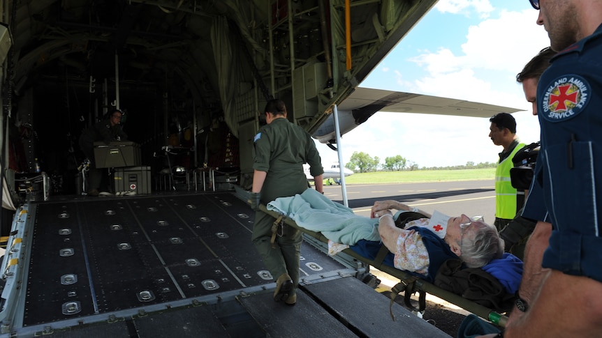 The sick and the elderly are being evacuated by a RAAF C-130 crew from the flood effected town of St George.
