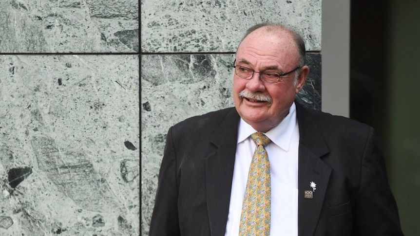 Warren Entsch smiles as he leans against a wall in Parliament.