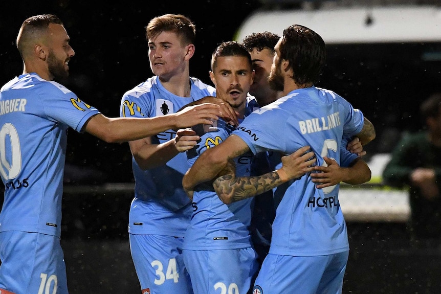 Jamie Maclaren is mobbed by his Melbourne City teammates