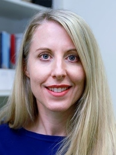 Portrait headshot of a research doctor smiling