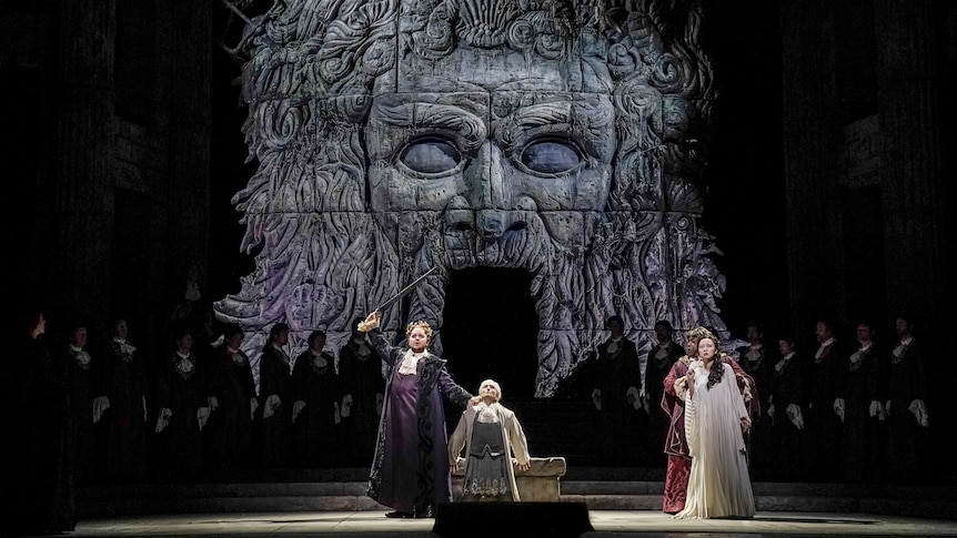 In front of a giant, forbidding image of the face of Neptune, Idomeneo prepares to sacrifice his son.