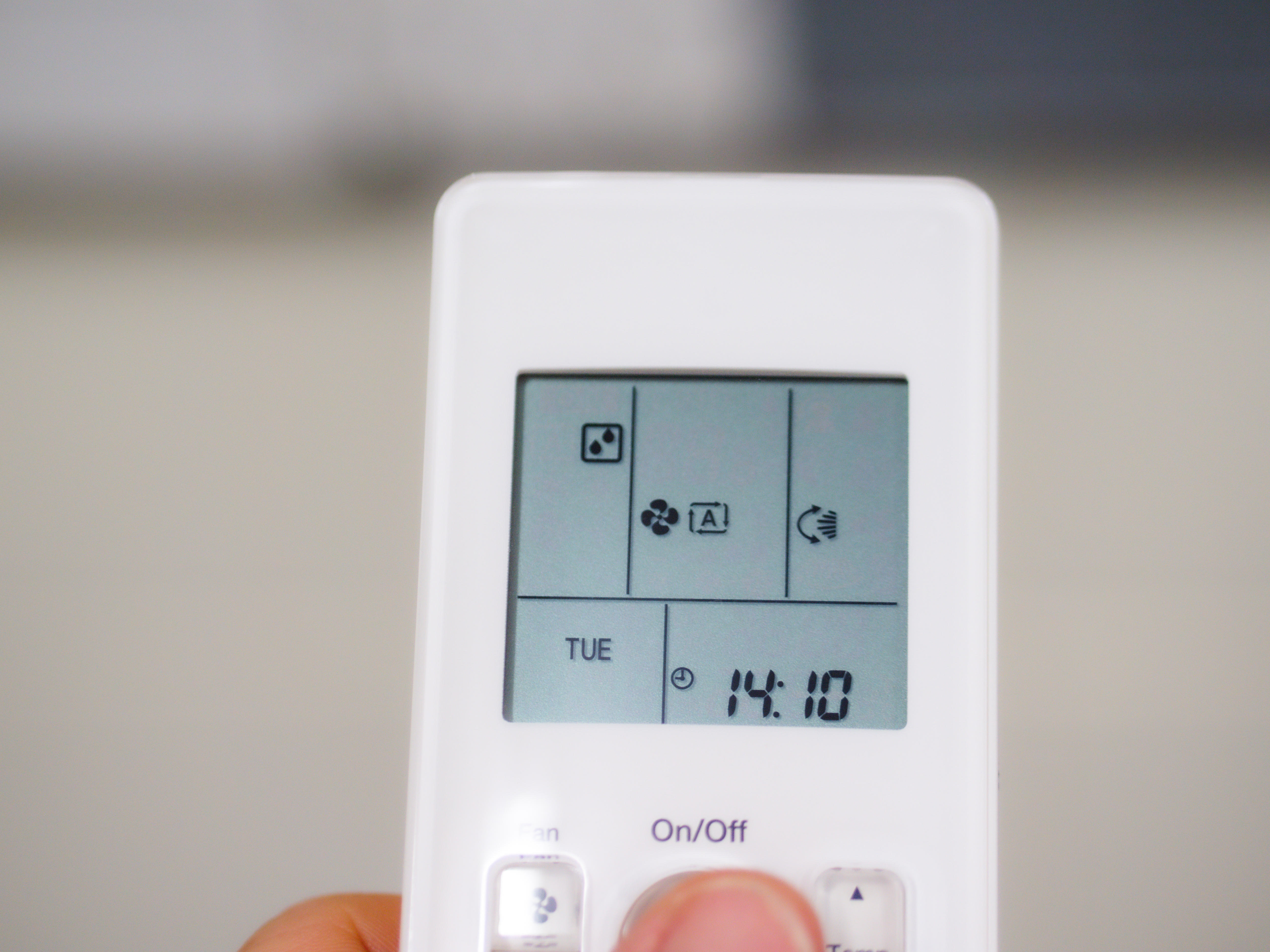 A closeup of an air conditioner remote.