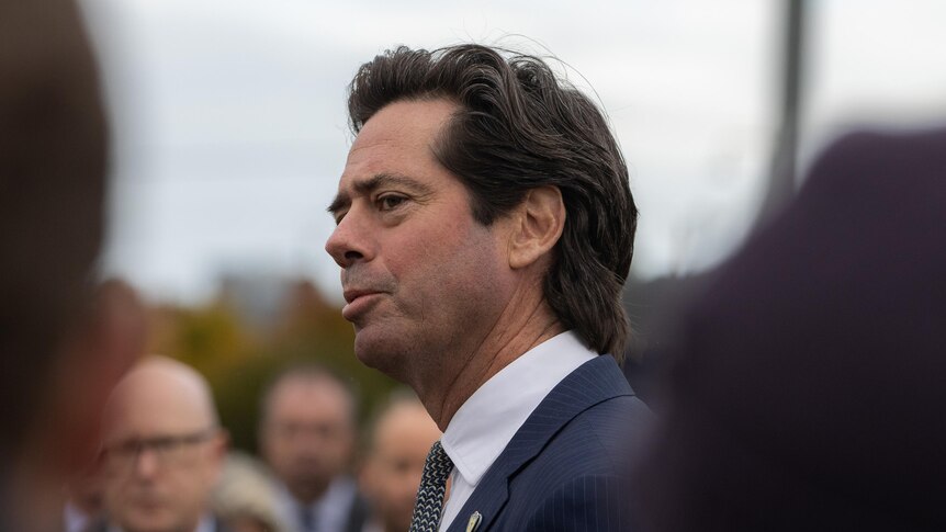 Gil McLachlan speaks to a group of people.