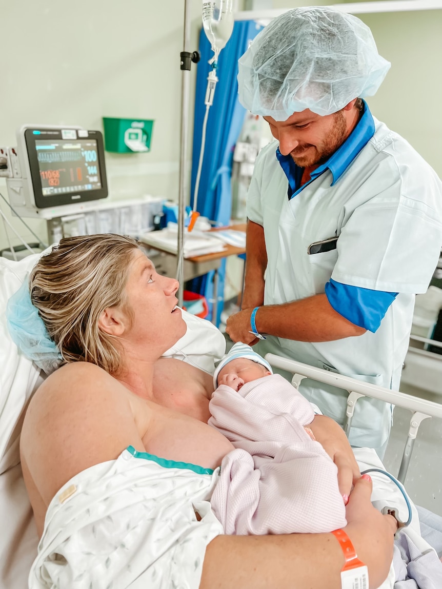 A woman and her partner in the hospital after just giving birth to a child.