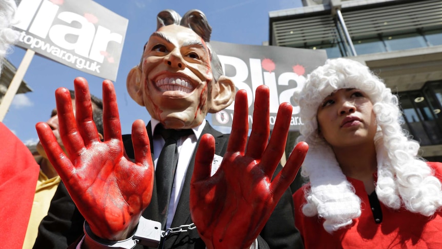 A demonstrator wearing a mask to impersonate Tony Blair