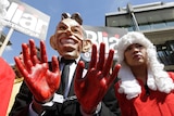 A demonstrator wearing a mask to impersonate Tony Blair