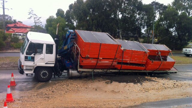 A truck carrying concrete slabs stuck in a n sink hole from a burst water main on the Leach Highway 13 December 2012