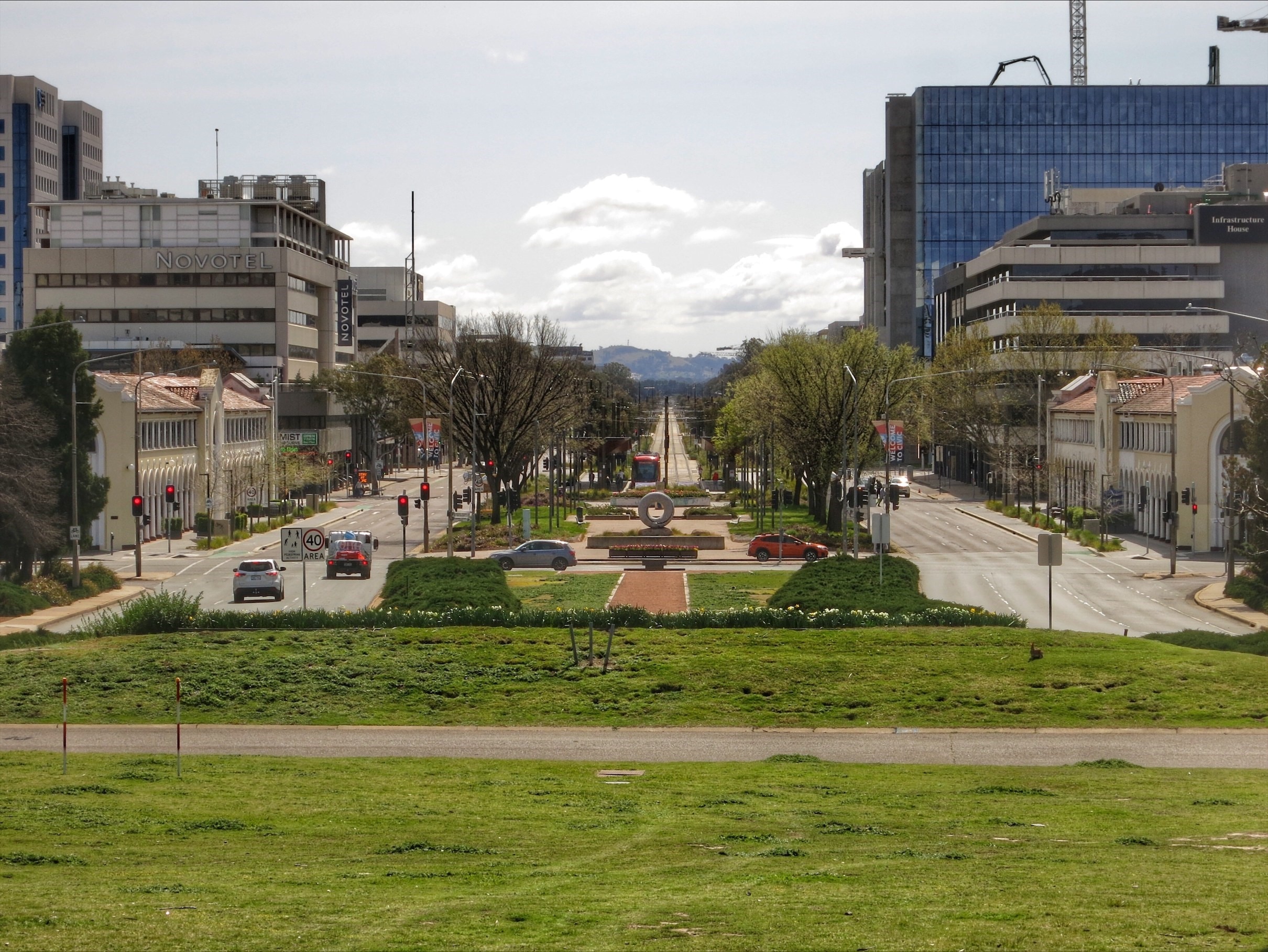 A main street lined with trees and greenery.
