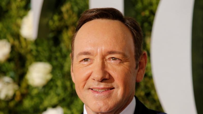 Kevin Spacey in a suit and bow tie smiles