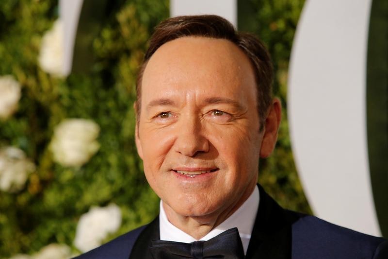 Kevin Spacey in a suit and bow tie smiles