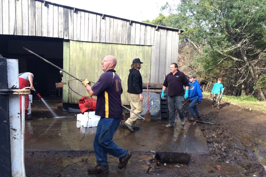 Latrobe Football Club members have been helping clean up flood damaged houses over the weekend June 2016