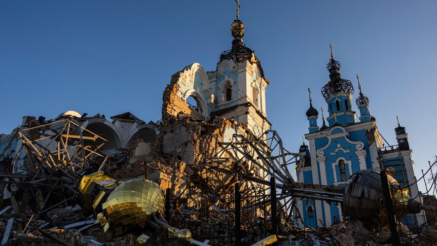 A cupola lies on the ground in front of the Orthodox Church which was destroyed by Russian forces.