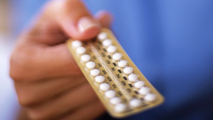 hand holding out a contraceptive pill packet