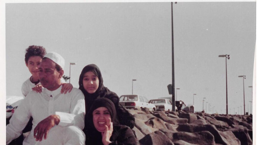 A young Manal Sl-sharif poses with her mother, father and brother on rocks