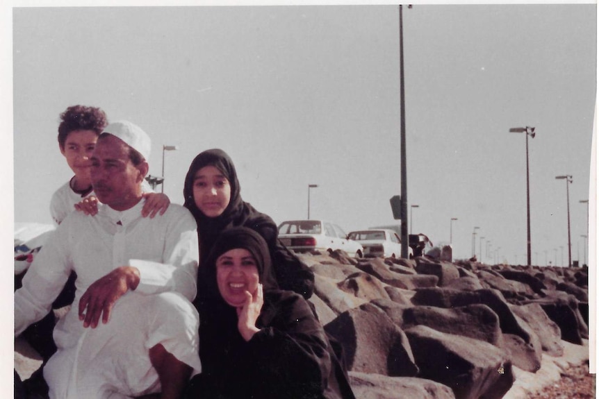 A young Manal Sl-sharif poses with her mother, father and brother on rocks