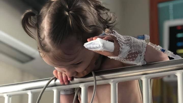 Wynter Gordon has her arm in a splint an oxygen nasal plug and monitors attached to her chest.