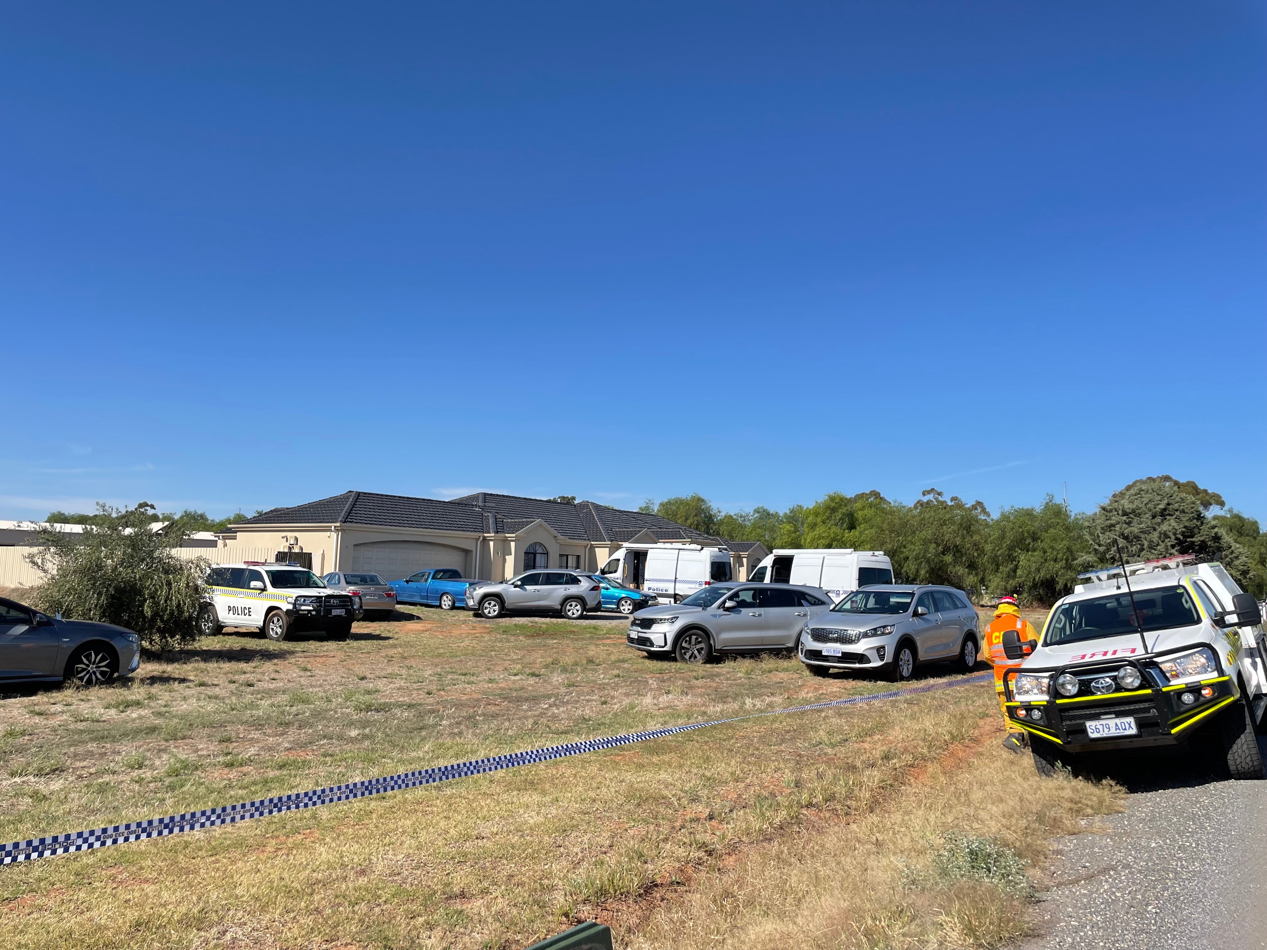 Police cars parked outside a property.