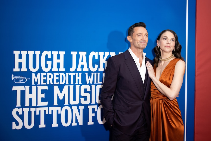 Hugh Jackman and Sutton Foster pose on the carpet during the opening night of The Music Man at the Winter Garden Theatre .