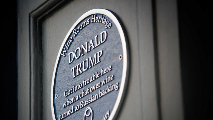 The dark blue plaque says "Donald Trump got into trouble here when a chat over wine turned to Russian hacking".
