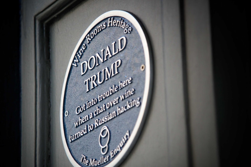 The dark blue plaque says "Donald Trump got into trouble here when a chat over wine turned to Russian hacking".