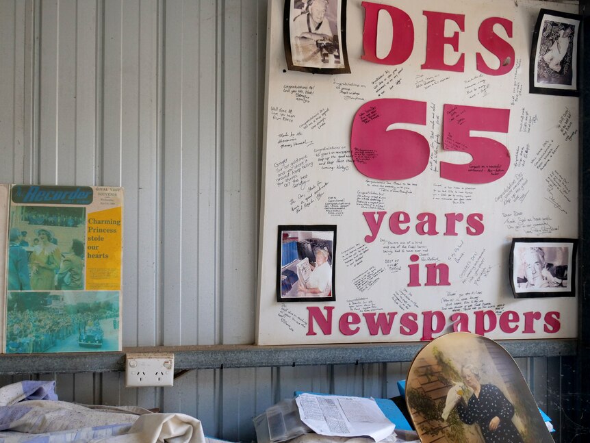 a photo of a shed with a number of posters of newspapers