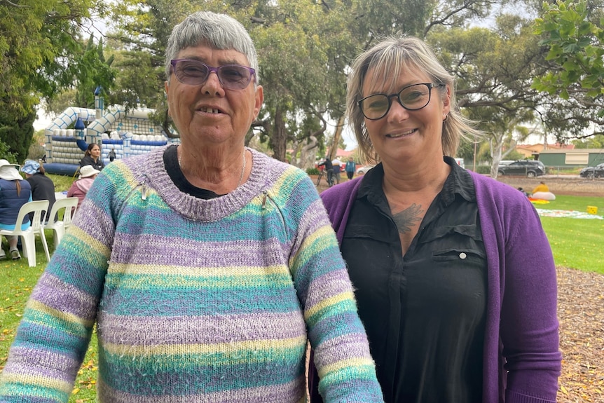 Two women standing together looking at camera