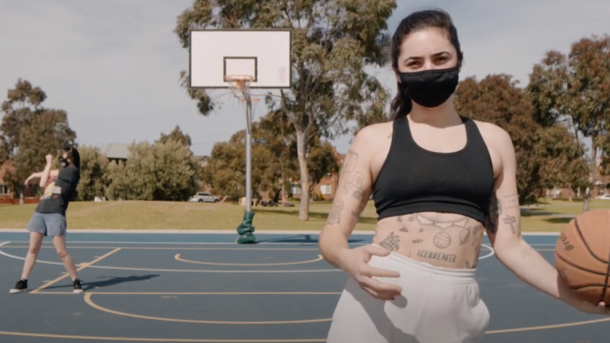 Still from Georgia Maq's remix of Gordi's 'Extraordinary Life'; two singers on a basketball court