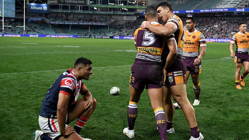 Jamayne Isaako of the Broncos (L) celebrates a try with David Fifita against the Roosters.