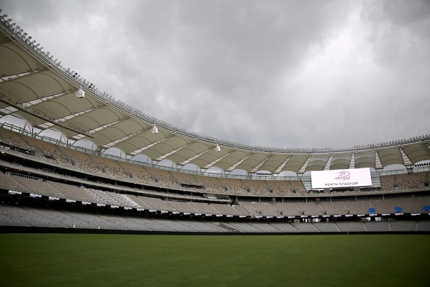 Empty interior of new Perth Stadium with big screen up one end.