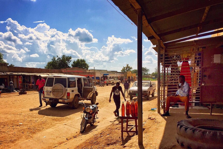 Petrol seller on the road to Nimule, South Sudan.