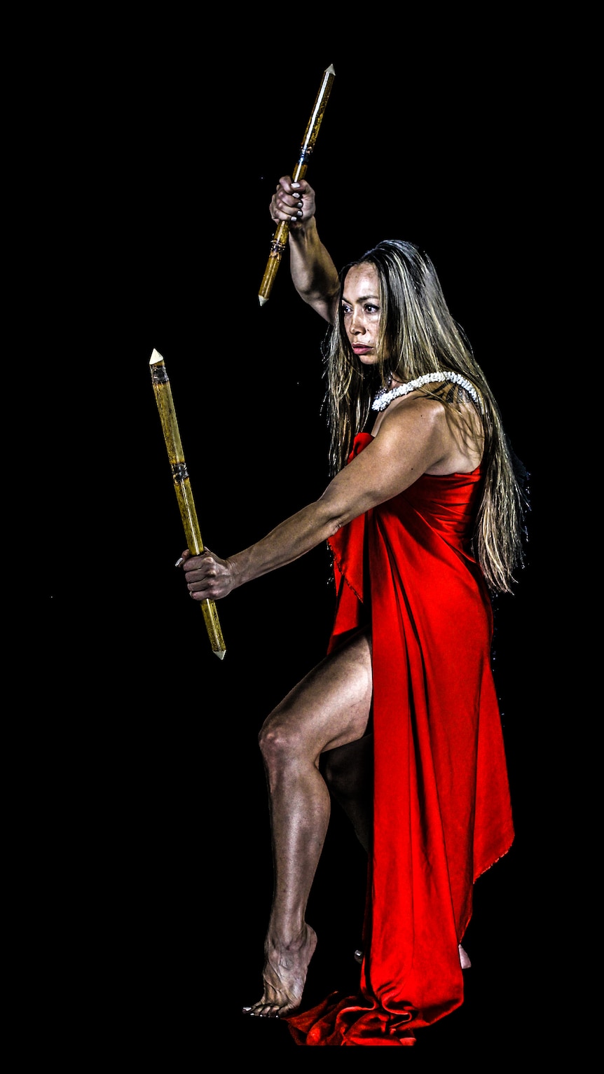Lua kumu Michelle Manu poses with a traditional weapons.