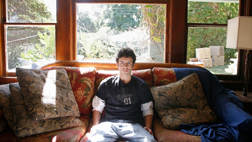 young man on a couch in parents' house
