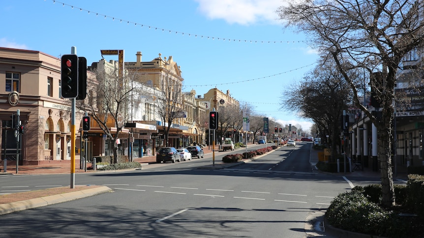 Town street with cars parked either side