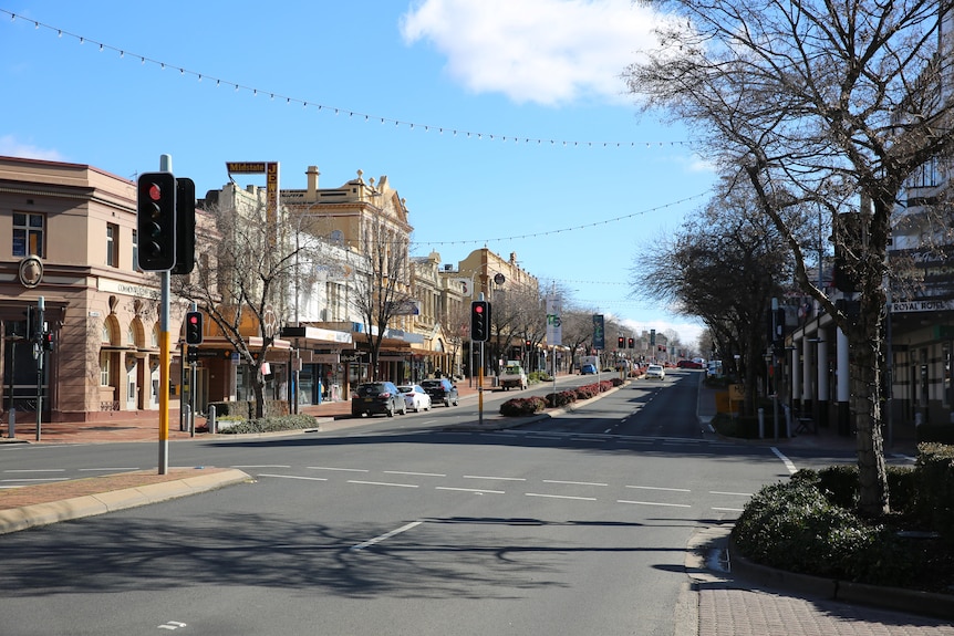 Town street with cars parked either side