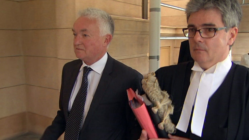 Adrian Hatch leaves court in Adelaide with lawyer Anthony Crocker.