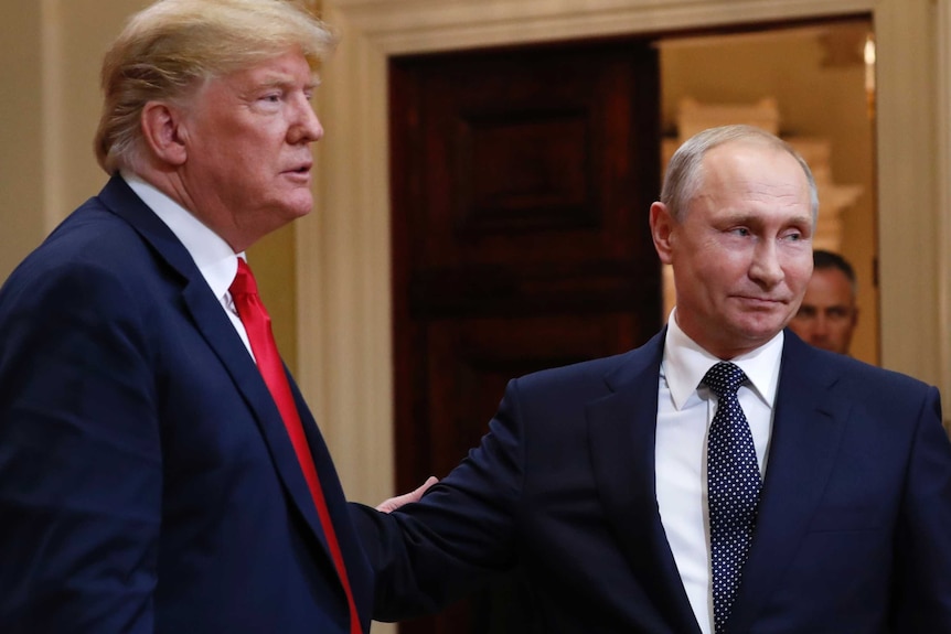 US President Donald Trump and Russian President Vladimir Putin leave a media conference.