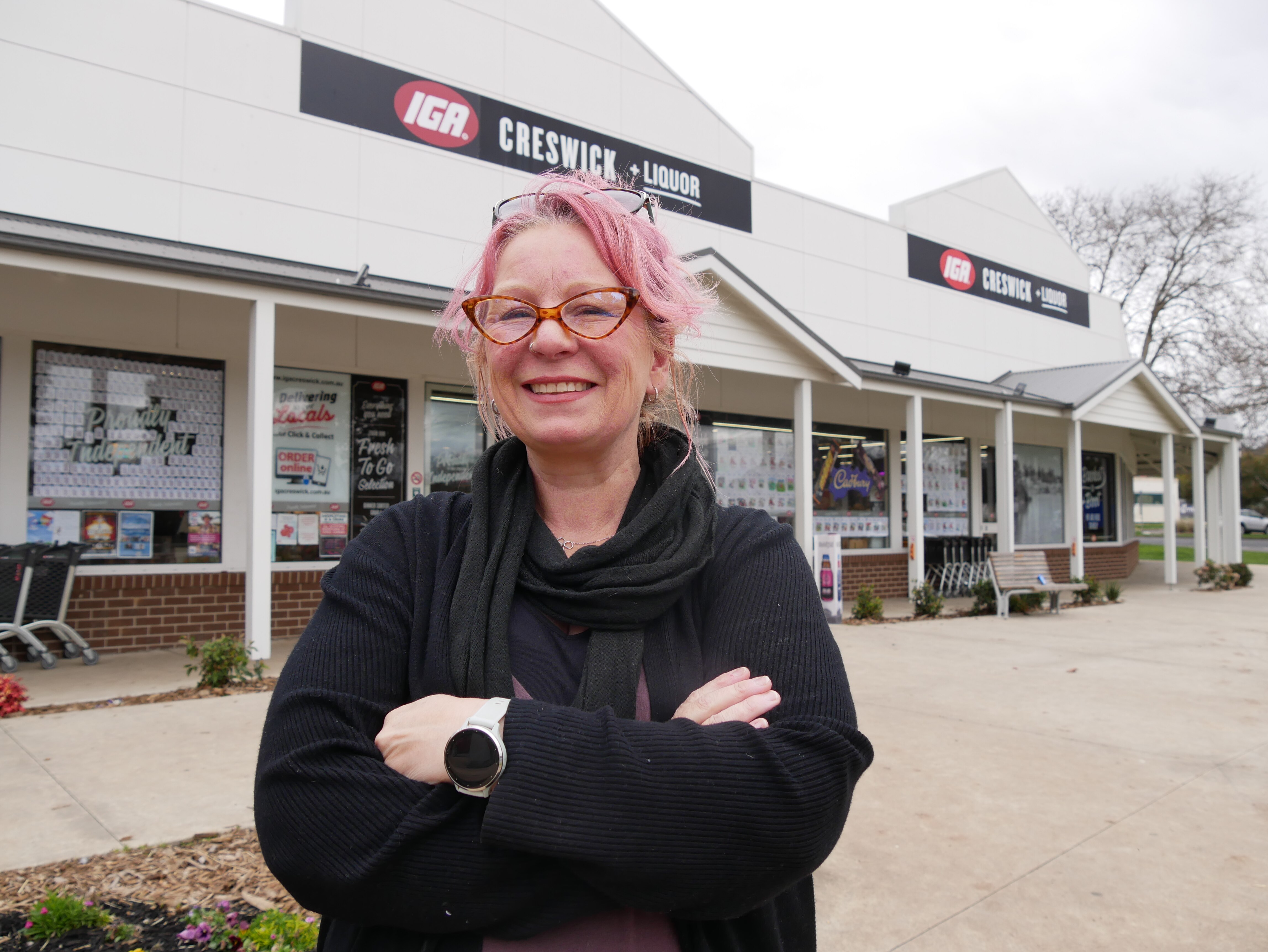 A woman standing in front of IGA in Creswick