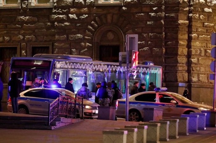 Security officers stand on the site of a shooting incident.