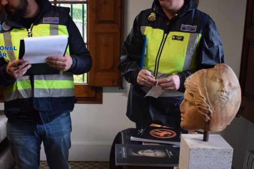 Spanish police with seized artefacts relating to Jaume Bagot.