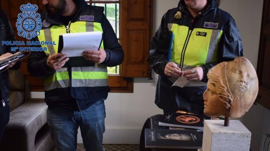 Spanish police with seized artefacts relating to Jaume Bagot.