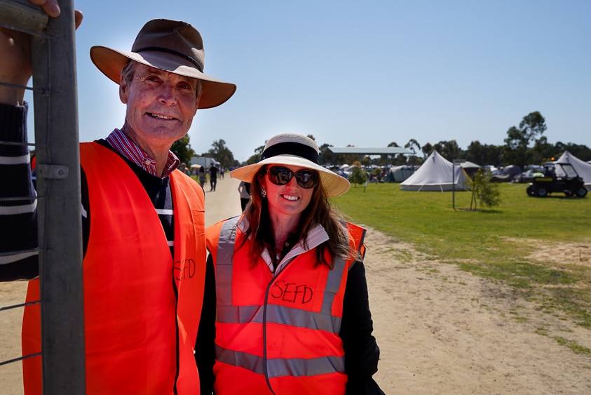 Two Lucindale locals in volunteer vests pose for a photo by the campgrounds gate.