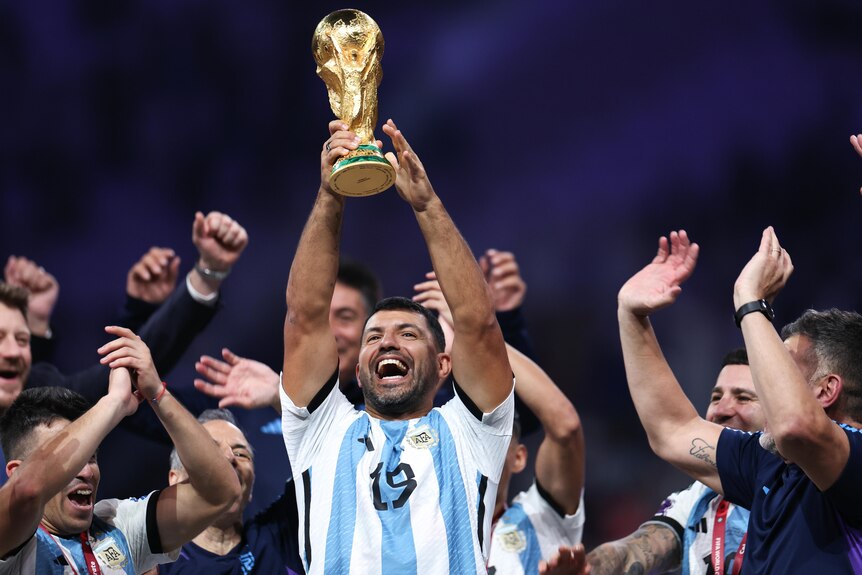 Former Argentina player Sergio Aguero lifts the FIFA World Cup trophy during celebrations after the Qatar final.