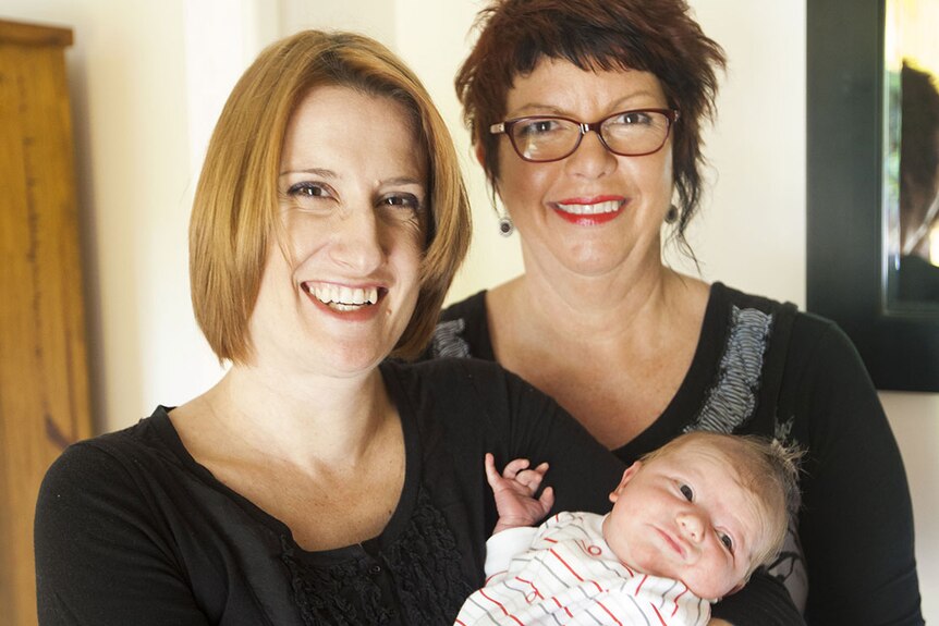 Christine Percy with her son James, and her midwife Karen Hayes in Brisbane in 2013