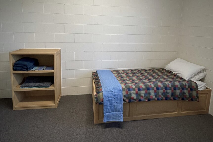 Bed and clothes storage in youth prison cell accommodation.