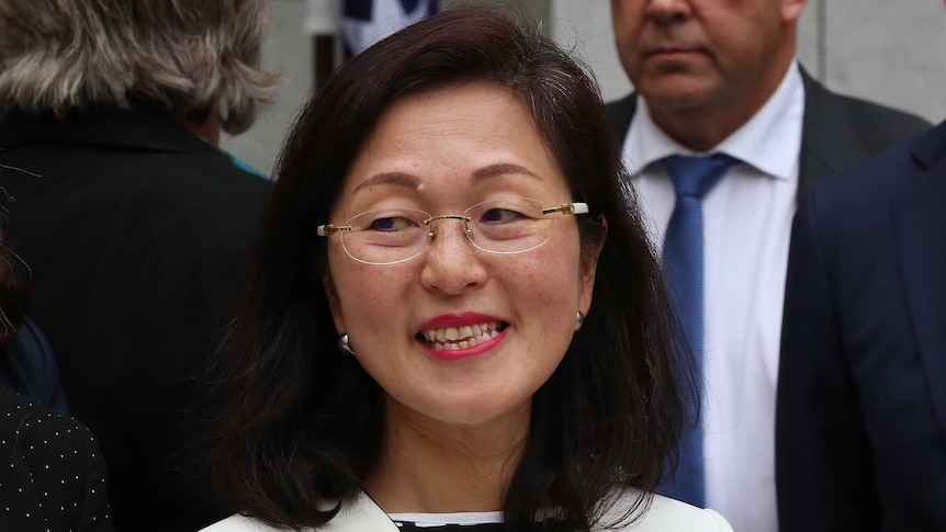 Gladys Liu smiles as she's surrounded by other newly elected politicians