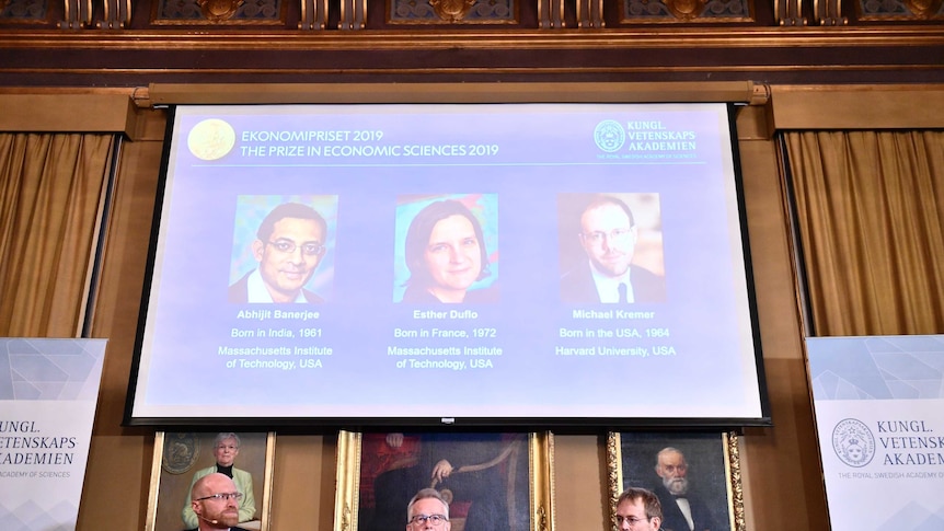 Nobel prize judges sit at wooden table for annoucement