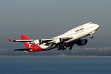 A Qantas plane takes off over Sydney.