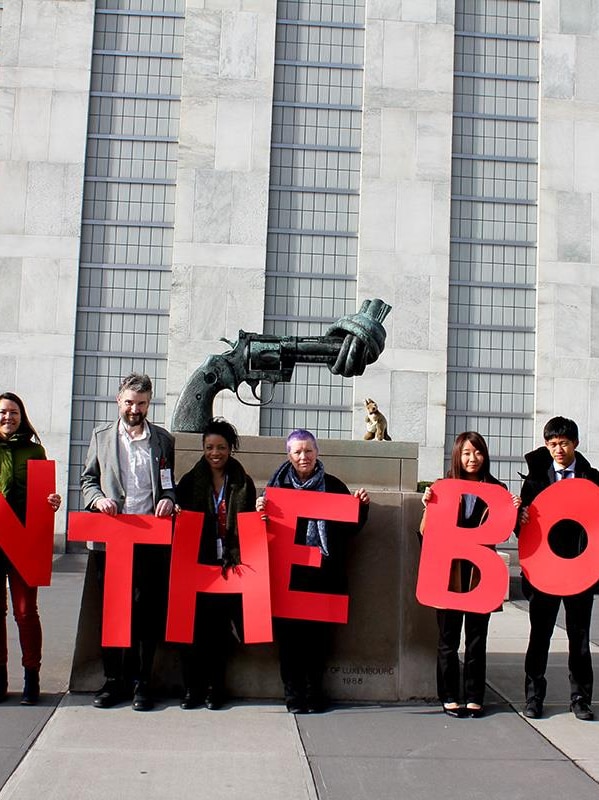 ICAN campaigners outside of the United Nations holding up letters spelling Ban the Bomb.