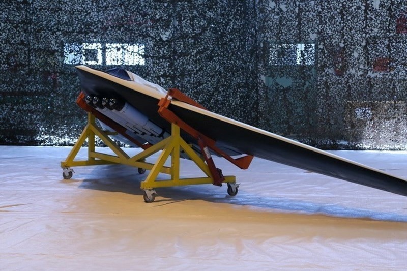 A Saegheh drone equipped with four bombs sits in a warehouse.
