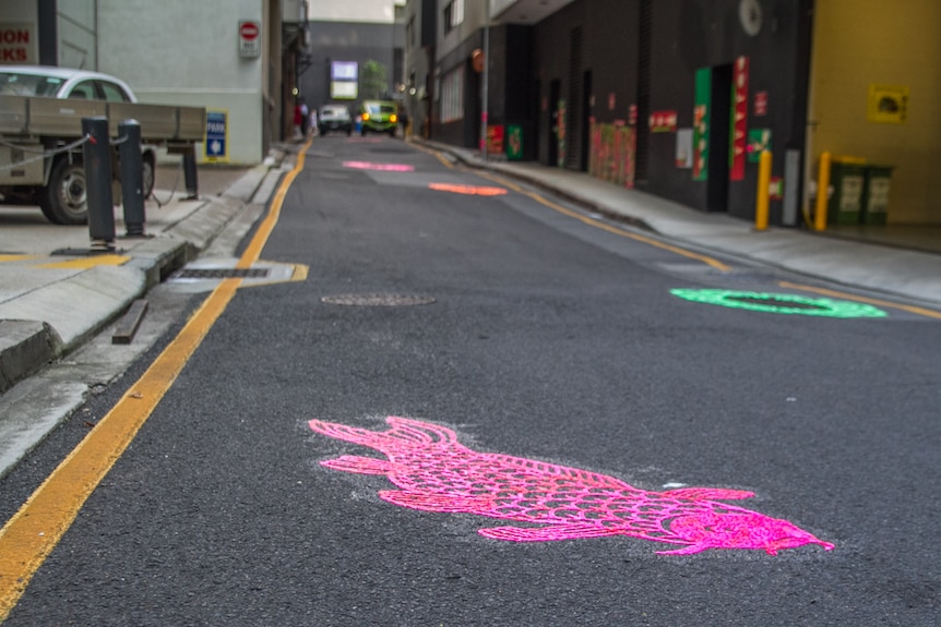 Fish and aquatic plant flowers weaved through the laneway.